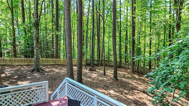 107 Oak Ridge Ct, Williamsburg, VA 23188 - fenced backyard with a wooden deck and a wooded view