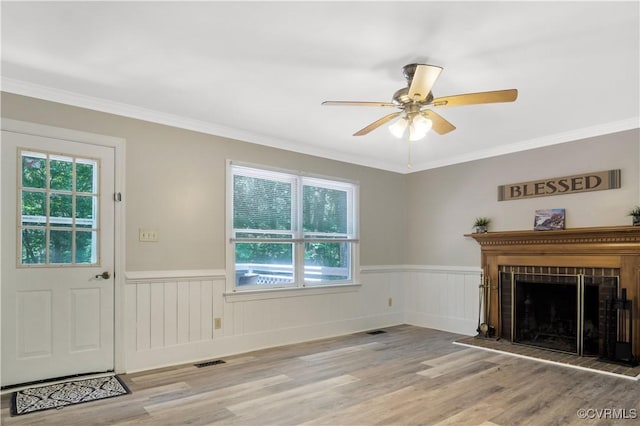 107 Oak Ridge Ct, Williamsburg, VA 23188 - unfurnished living room with wainscoting, plenty of natural light, ceiling fan, wood finished floors, and ornamental molding
