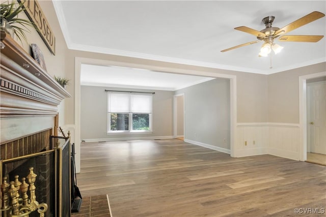 107 Oak Ridge Ct, Williamsburg, VA 23188 - unfurnished living room with wood finished floors, a ceiling fan, crown molding, wainscoting, and a fireplace with flush hearth