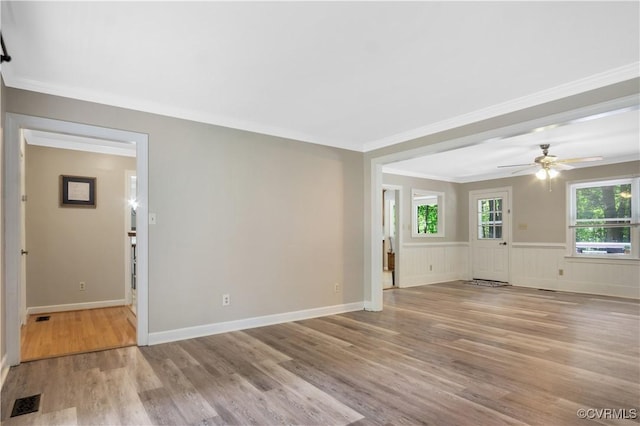 107 Oak Ridge Ct, Williamsburg, VA 23188 - unfurnished room with wood finished floors, a ceiling fan, crown molding, and a wainscoted wall