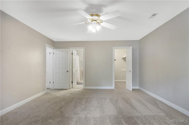 107 Oak Ridge Ct, Williamsburg, VA 23188 - unfurnished bedroom with light carpet, a spacious closet, ensuite bath, and ceiling fan