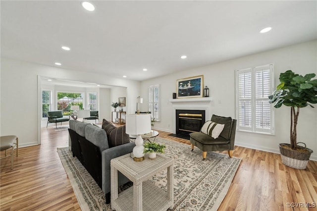 6030 Pond Place Way, Mechanicsville, VA 23111 - living room with light wood-style flooring, recessed lighting, and a fireplace with flush hearth