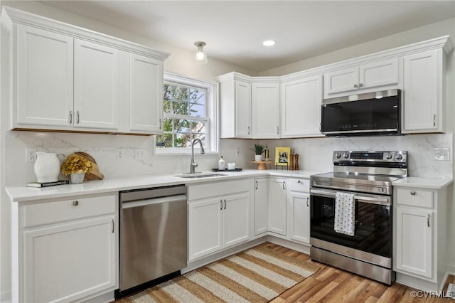 6030 Pond Place Way, Mechanicsville, VA 23111 - kitchen featuring stainless steel appliances, light countertops, white cabinets, light wood finished floors, and recessed lighting