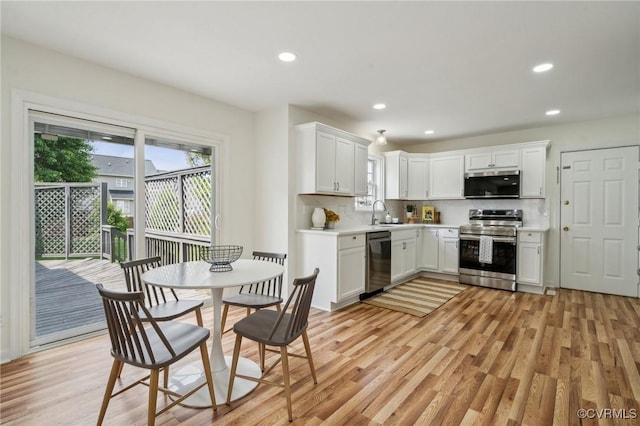 6030 Pond Place Way, Mechanicsville, VA 23111 - kitchen with appliances with stainless steel finishes, light wood-type flooring, recessed lighting, light countertops, and white cabinetry