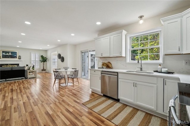 6030 Pond Place Way, Mechanicsville, VA 23111 - kitchen featuring stainless steel dishwasher, light wood-style floors, light countertops, recessed lighting, and a fireplace