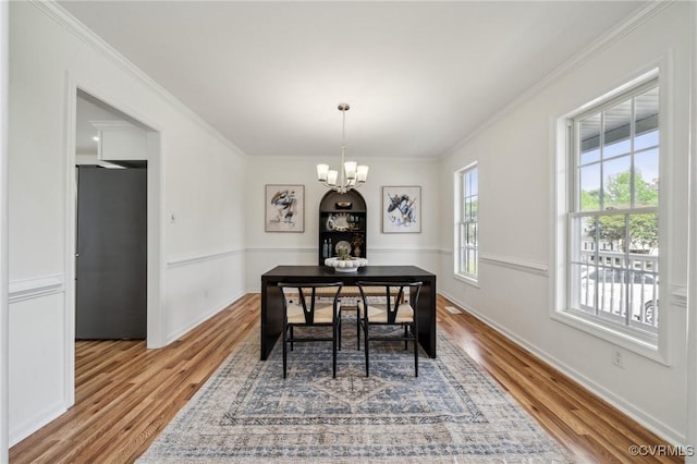 6030 Pond Place Way, Mechanicsville, VA 23111 - dining space featuring a chandelier, wood finished floors, and crown molding