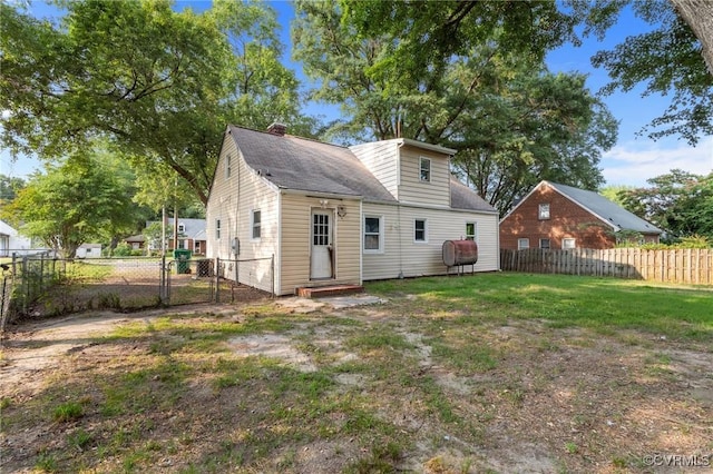 4123 Bremner Blvd, Henrico, VA 23228 - back of house featuring a gate, a chimney, entry steps, and heating fuel