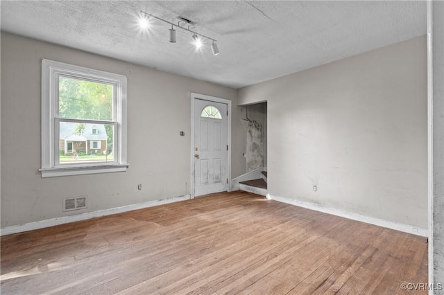 4123 Bremner Blvd, Henrico, VA 23228 - entryway with wood finished floors, track lighting, plenty of natural light, stairway, and a textured ceiling