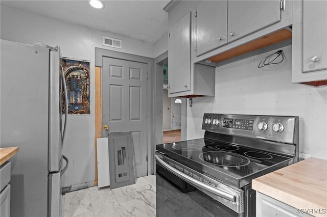 4123 Bremner Blvd, Henrico, VA 23228 - kitchen featuring appliances with stainless steel finishes, light marble finish flooring, butcher block counters, and gray cabinetry