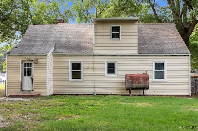 4123 Bremner Blvd, Henrico, VA 23228 - back of property featuring heating fuel, a chimney, a lawn, and a shingled roof