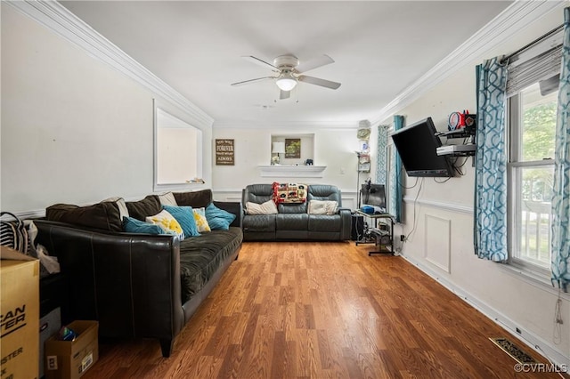 9220 Brocket Dr, Midlothian, VA 23112 - living room featuring a ceiling fan, wood finished floors, crown molding, and a wainscoted wall
