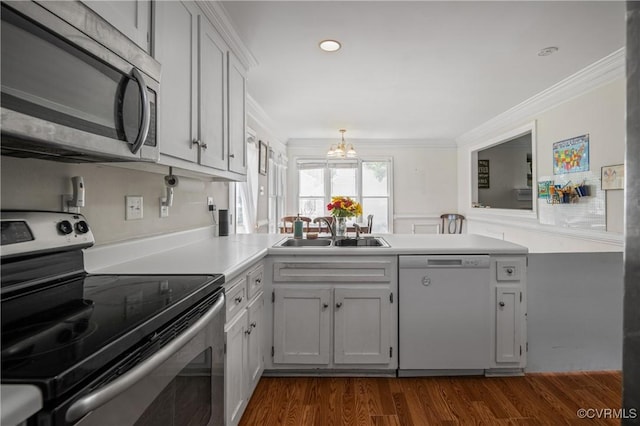 9220 Brocket Dr, Midlothian, VA 23112 - kitchen with appliances with stainless steel finishes, crown molding, a chandelier, dark wood-style floors, and light countertops