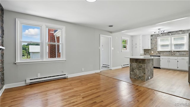 6010 Courthouse Rd, Prince George, VA 23875 - kitchen featuring a baseboard heating unit, a center island, stainless steel dishwasher, and white cabinetry