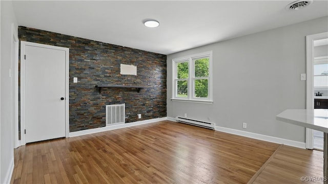 6010 Courthouse Rd, Prince George, VA 23875 - unfurnished living room with a baseboard heating unit and wood finished floors