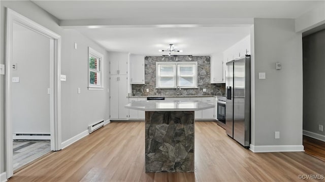 6010 Courthouse Rd, Prince George, VA 23875 - kitchen featuring stainless steel fridge, baseboard heating, a baseboard radiator, backsplash, and white cabinetry