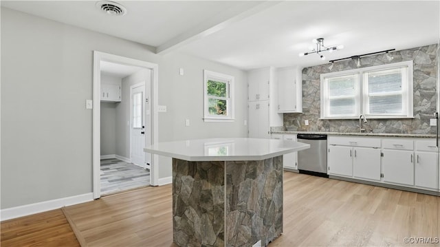 6010 Courthouse Rd, Prince George, VA 23875 - kitchen with stainless steel dishwasher, light wood-type flooring, healthy amount of natural light, white cabinetry, and beamed ceiling