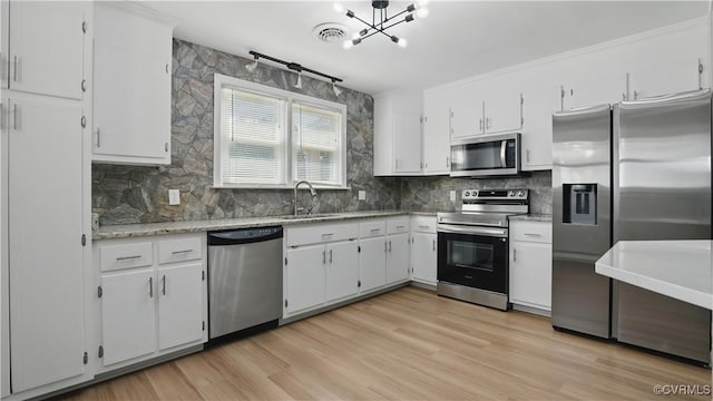 6010 Courthouse Rd, Prince George, VA 23875 - kitchen with appliances with stainless steel finishes, tasteful backsplash, white cabinetry, and a chandelier