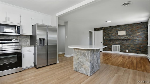 6010 Courthouse Rd, Prince George, VA 23875 - kitchen featuring appliances with stainless steel finishes, light wood-style flooring, light countertops, and white cabinetry