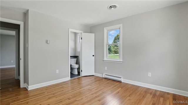 6010 Courthouse Rd, Prince George, VA 23875 - unfurnished bedroom with baseboard heating, light wood-style flooring, and connected bathroom