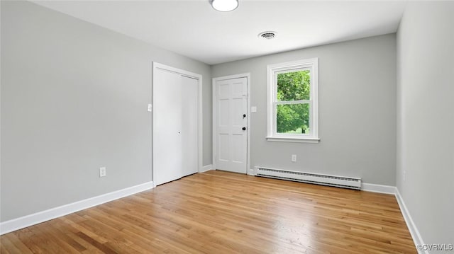 6010 Courthouse Rd, Prince George, VA 23875 - spare room featuring a baseboard heating unit and light wood-style floors