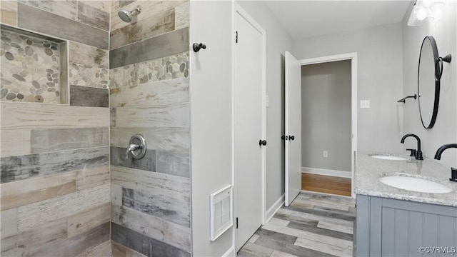 6010 Courthouse Rd, Prince George, VA 23875 - bathroom featuring a tile shower, double vanity, and wood finished floors