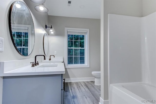12309 Main St, Stony Creek, VA 23882 - bathroom with double vanity, wood finished floors, and bathtub / shower combination