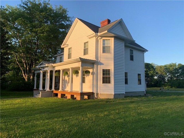12309 Main St, Stony Creek, VA 23882 - view of front facade featuring a front lawn, a chimney, and a porch