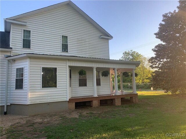 12309 Main St, Stony Creek, VA 23882 - back of house featuring covered porch and a lawn