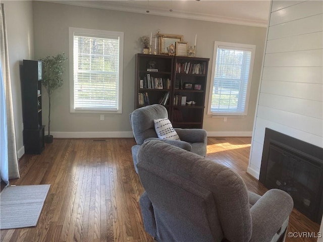 12309 Main St, Stony Creek, VA 23882 - living area featuring crown molding, wood finished floors, and a large fireplace