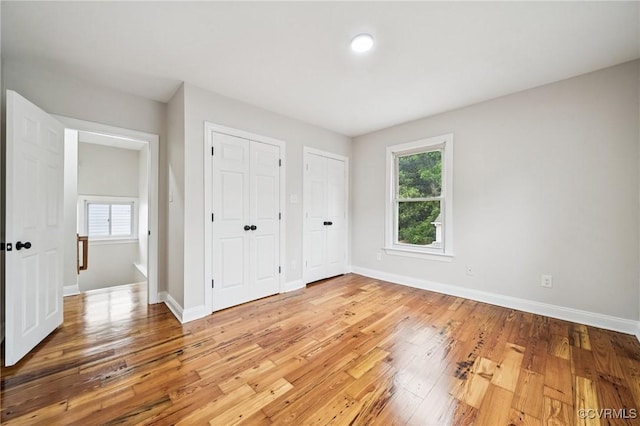 627 Colonial Ave, Colonial Heights, VA 23834 - unfurnished bedroom featuring multiple closets and light wood-style flooring