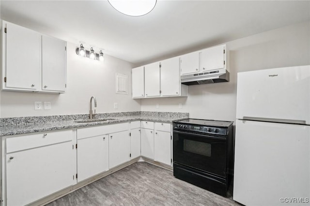 627 Colonial Ave, Colonial Heights, VA 23834 - kitchen with freestanding refrigerator, black / electric stove, under cabinet range hood, white cabinetry, and light stone countertops