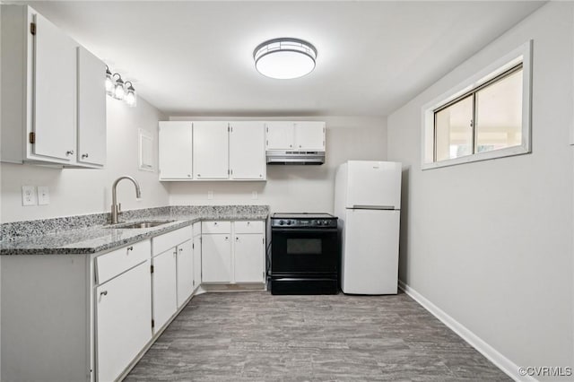 627 Colonial Ave, Colonial Heights, VA 23834 - kitchen featuring freestanding refrigerator, under cabinet range hood, stove, and white cabinets