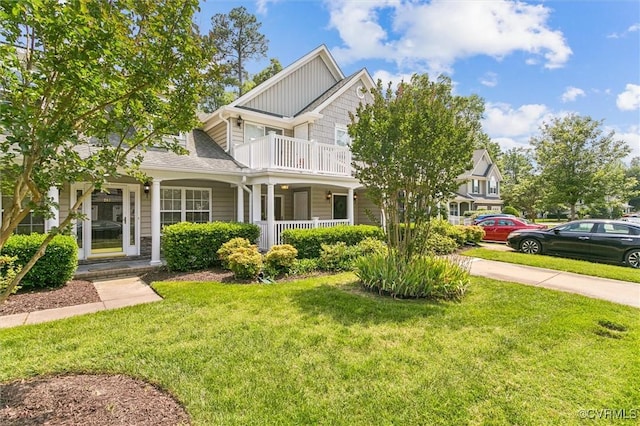 262 Claiborne Dr, Williamsburg, VA 23185 - craftsman-style home featuring covered porch, a front lawn, a balcony, and board and batten siding