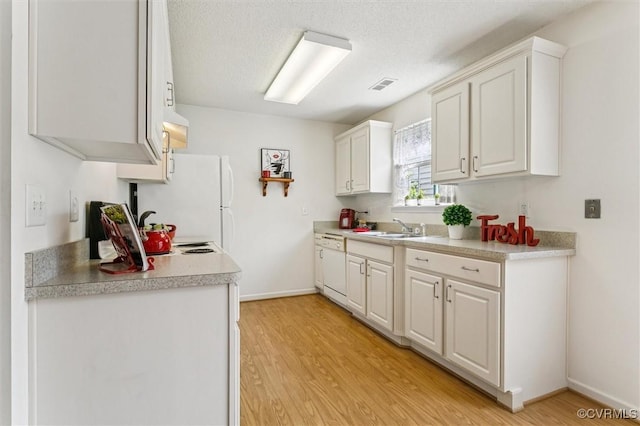 262 Claiborne Dr, Williamsburg, VA 23185 - kitchen with light wood-style flooring, light countertops, white cabinets, white appliances, and a textured ceiling