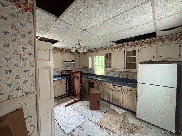 6690 4th Ave, Henrico, VA 23231 - kitchen with freestanding refrigerator, dark countertops, a paneled ceiling, under cabinet range hood, and stainless steel electric range