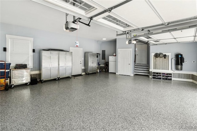 8000 Clancy Pl, Chesterfield, VA 23838 - garage featuring freestanding refrigerator, a garage door opener, and electric panel