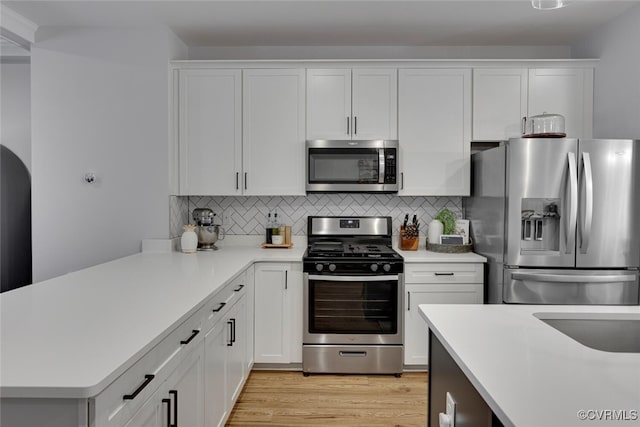 6504 Sanford Springs Cv, Midlothian, VA 23112 - kitchen featuring appliances with stainless steel finishes, light countertops, white cabinets, and tasteful backsplash