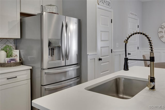 6504 Sanford Springs Cv, Midlothian, VA 23112 - kitchen with stainless steel fridge, light countertops, white cabinets, decorative backsplash, and a wainscoted wall