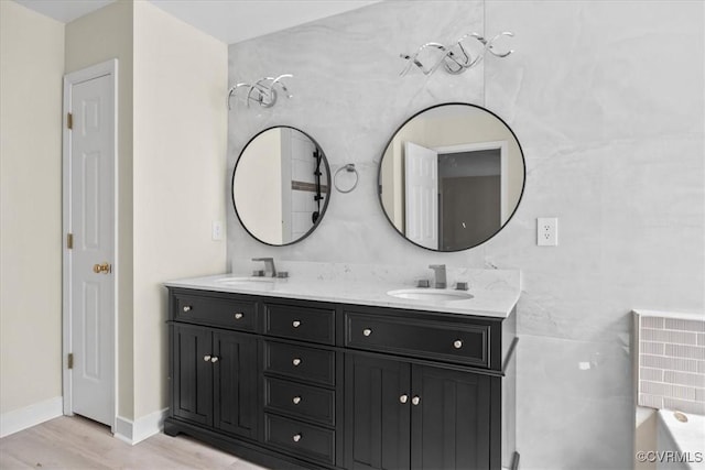 13713 Nile Rd, Chester, VA 23831 - bathroom featuring double vanity, wood finished floors, and a tub to relax in