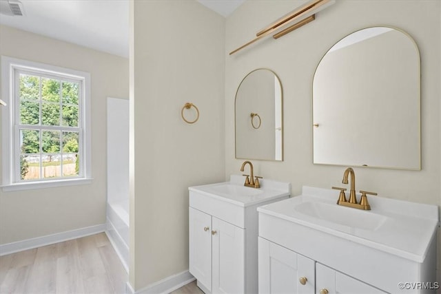 13713 Nile Rd, Chester, VA 23831 - full bath with two vanities, wood finished floors, and shower / bath combination