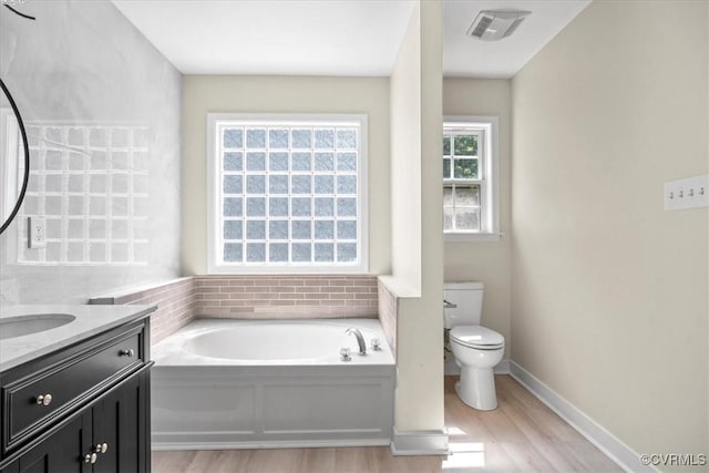 13713 Nile Rd, Chester, VA 23831 - bathroom featuring wood finished floors, vanity, and a bath