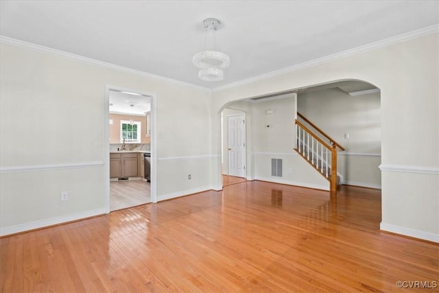 13713 Nile Rd, Chester, VA 23831 - unfurnished room featuring arched walkways, light wood finished floors, stairs, ornamental molding, and a chandelier