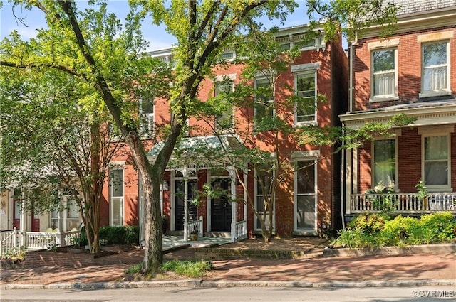 2417 E Grace St, Richmond, VA 23223 - view of front facade with a porch and brick siding