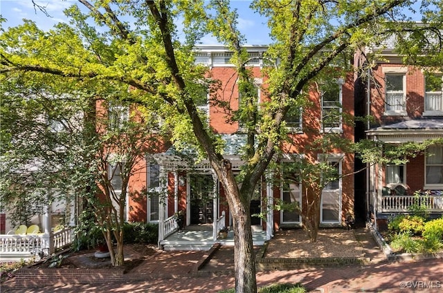 2417 E Grace St, Richmond, VA 23223 - obstructed view of property featuring brick siding