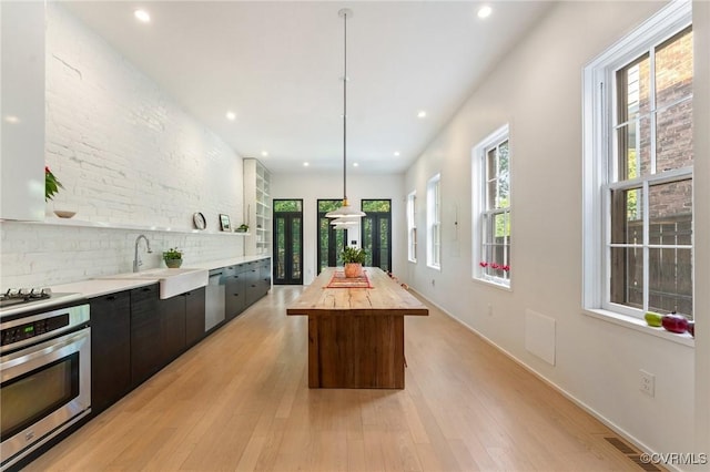 2417 E Grace St, Richmond, VA 23223 - kitchen featuring stainless steel appliances, recessed lighting, light wood finished floors, modern cabinets, and a kitchen island