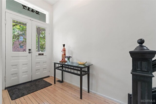 2417 E Grace St, Richmond, VA 23223 - foyer with light wood finished floors and baseboards