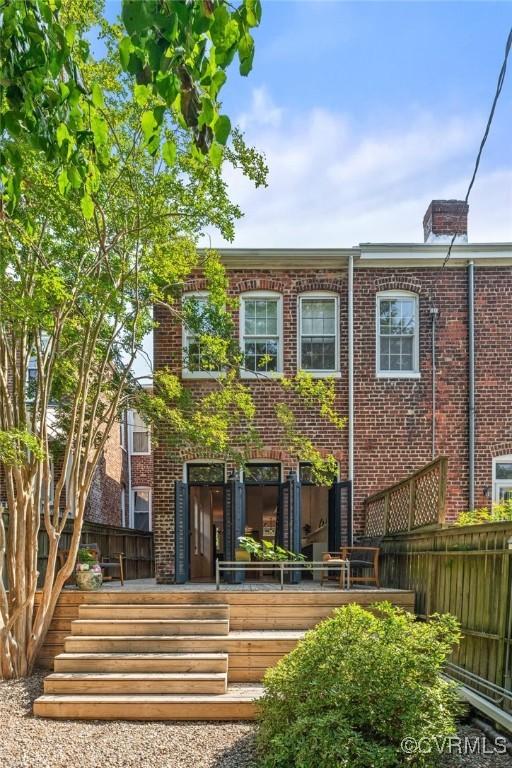 2417 E Grace St, Richmond, VA 23223 - rear view of property featuring brick siding and a deck