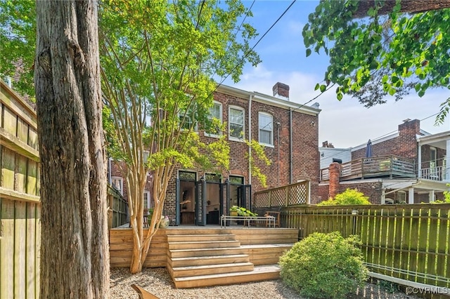 2417 E Grace St, Richmond, VA 23223 - rear view of house featuring brick siding and a chimney