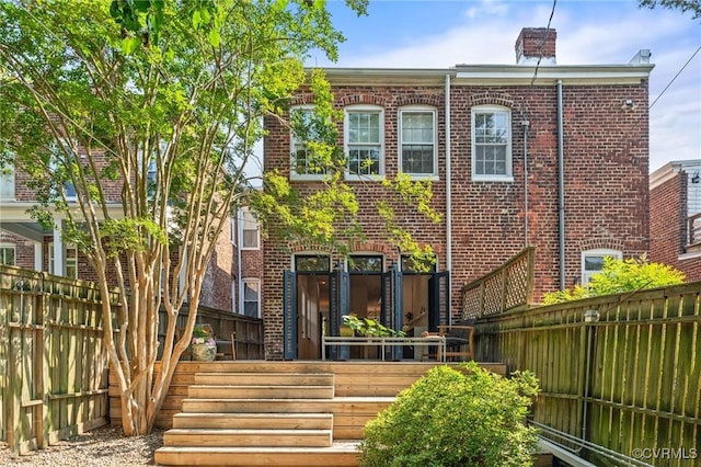 2417 E Grace St, Richmond, VA 23223 - rear view of house with brick siding and a chimney
