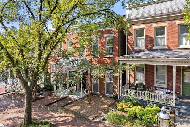 2417 E Grace St, Richmond, VA 23223 - view of front facade featuring brick siding and covered porch